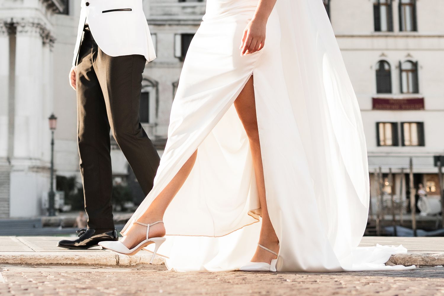 Elegant wedding attire details against classic Venetian architecture.