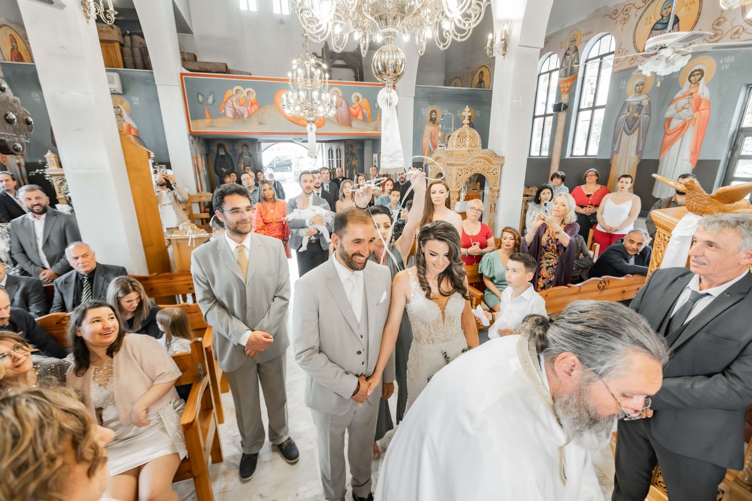 Wedding celebration inside a church with guests gathered for the ceremony.