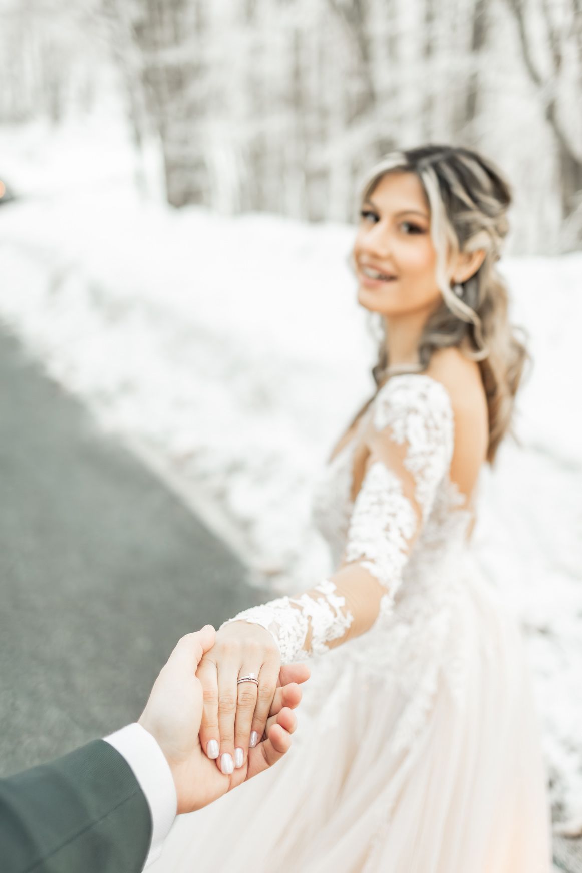 Close-up shots of wedding rings and held hands against snowy winter backdrop.
