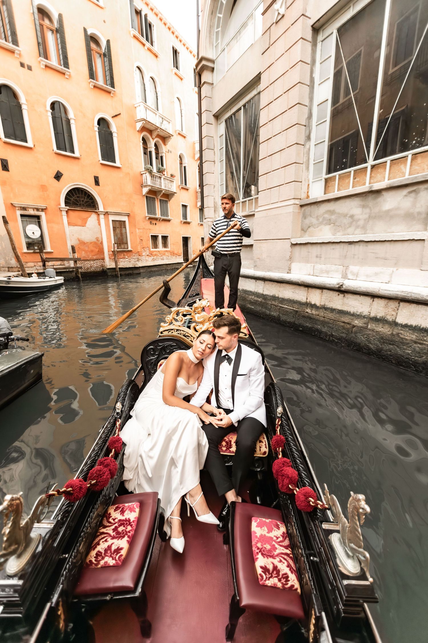 Wedding photography session in a gondola navigating Venice's picturesque waterways.