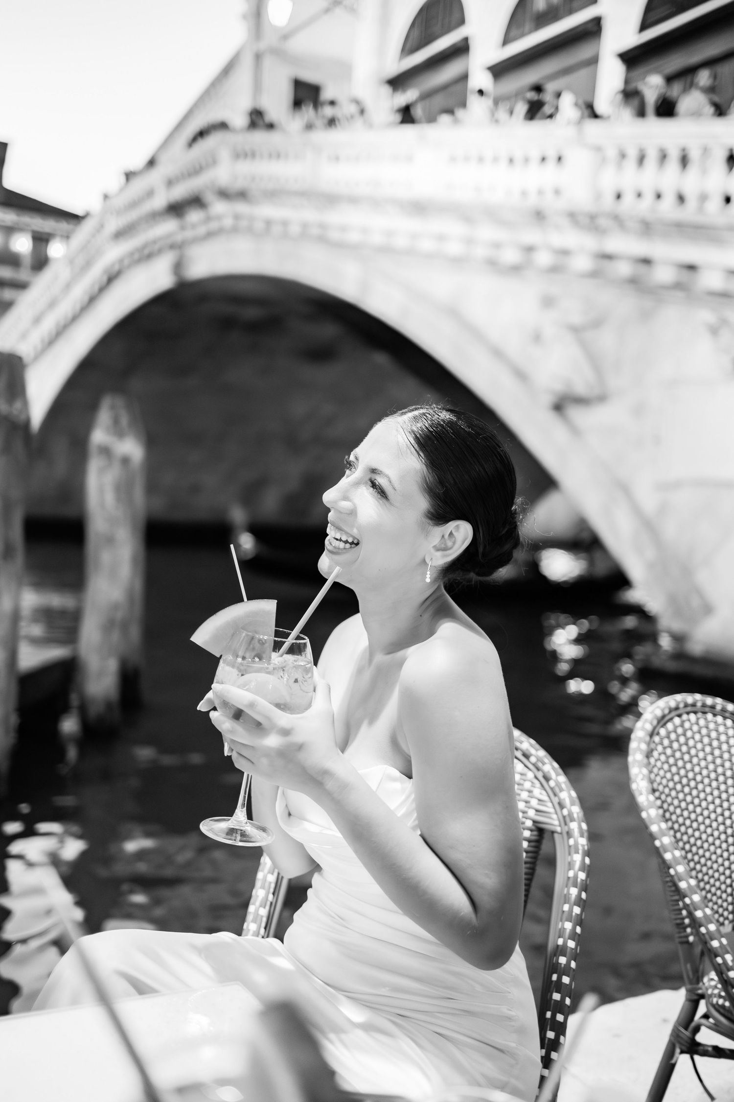 Joyful moments captured at an outdoor cafe along Venice's Grand Canal.