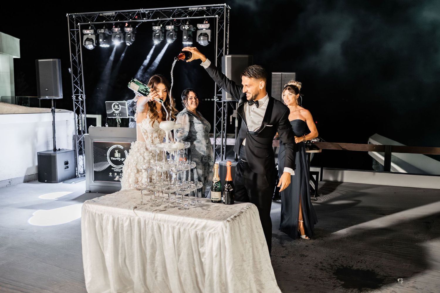 Elegant wedding reception setup with white tablecloths and decorative details.