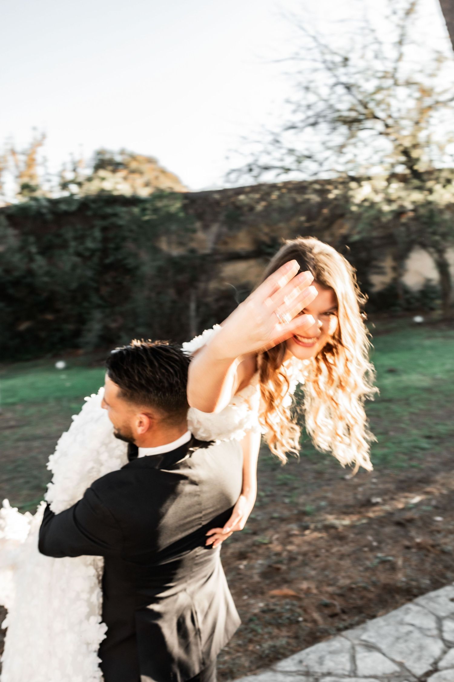Dancing couple captured in motion with flowing dress and natural lighting.