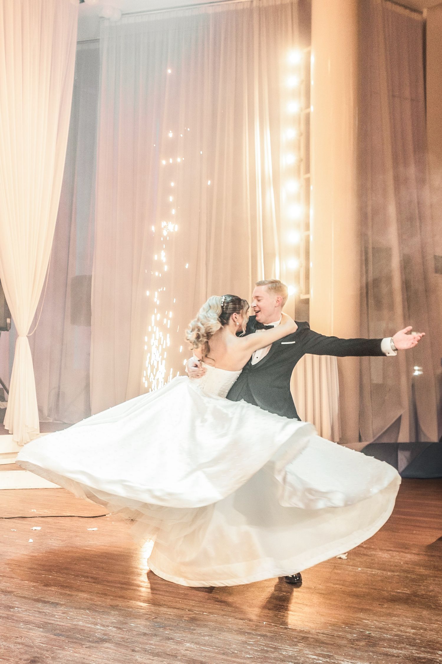 Dramatic wedding dance sequence with flowing white dress against sheer curtain backdrop.