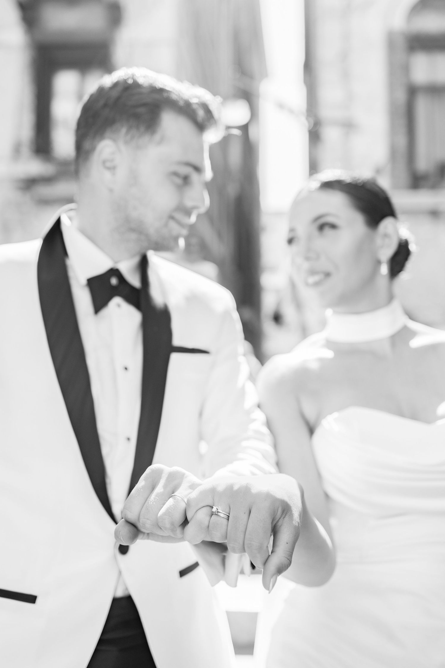 Close-up wedding photography showing tender moments and elegant white attire.