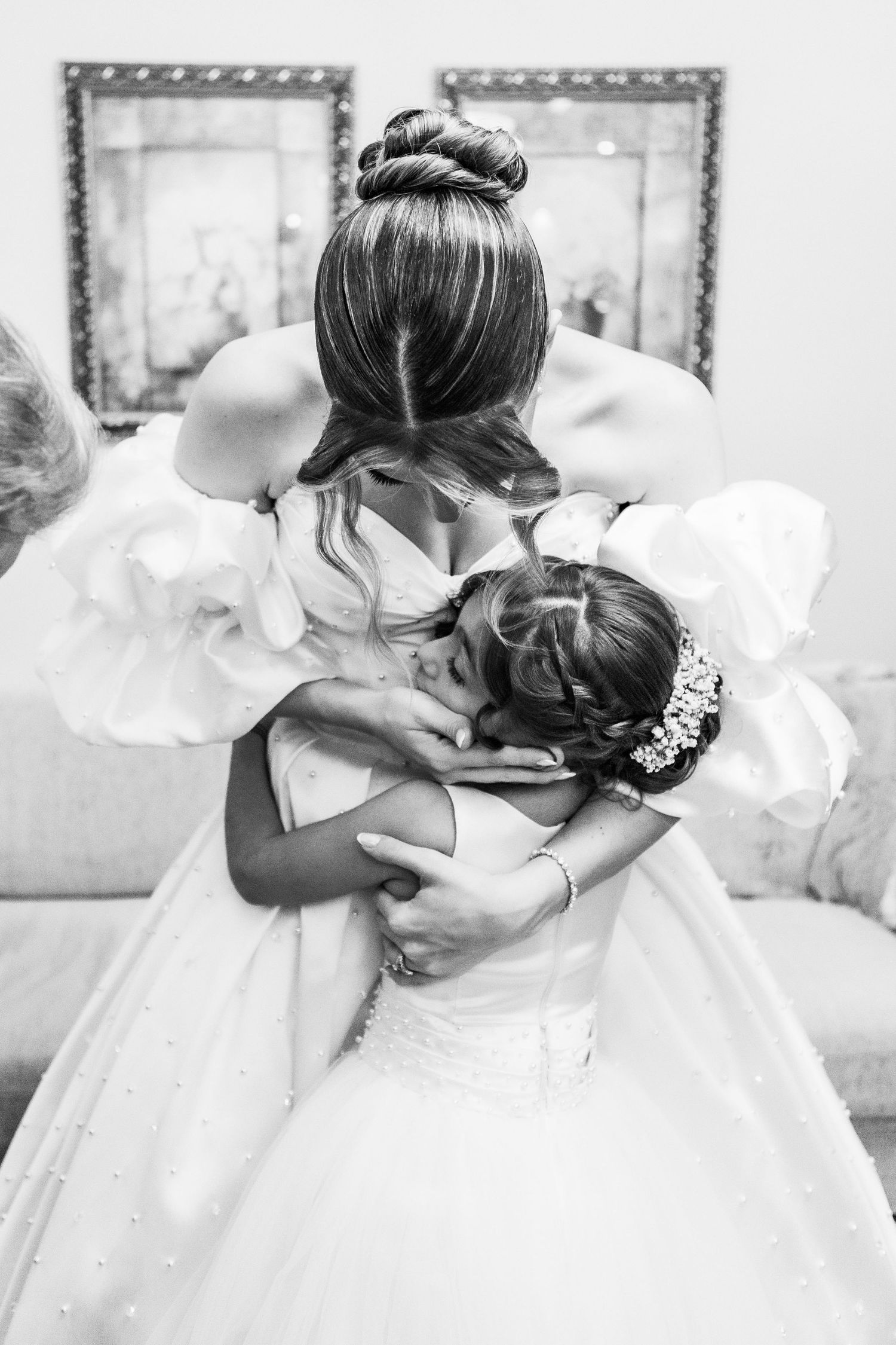 Black and white series showing emotional embrace with flowing wedding dress.