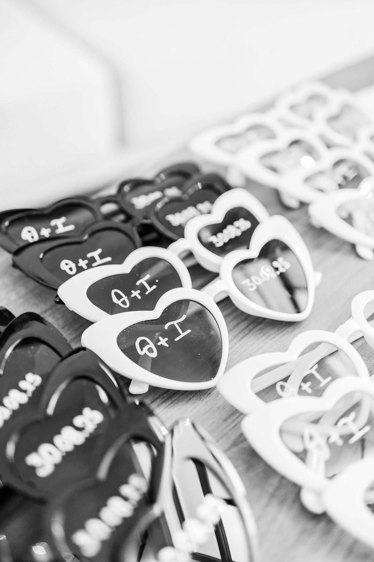 Black and white heart-shaped wedding favors arranged in a row.
