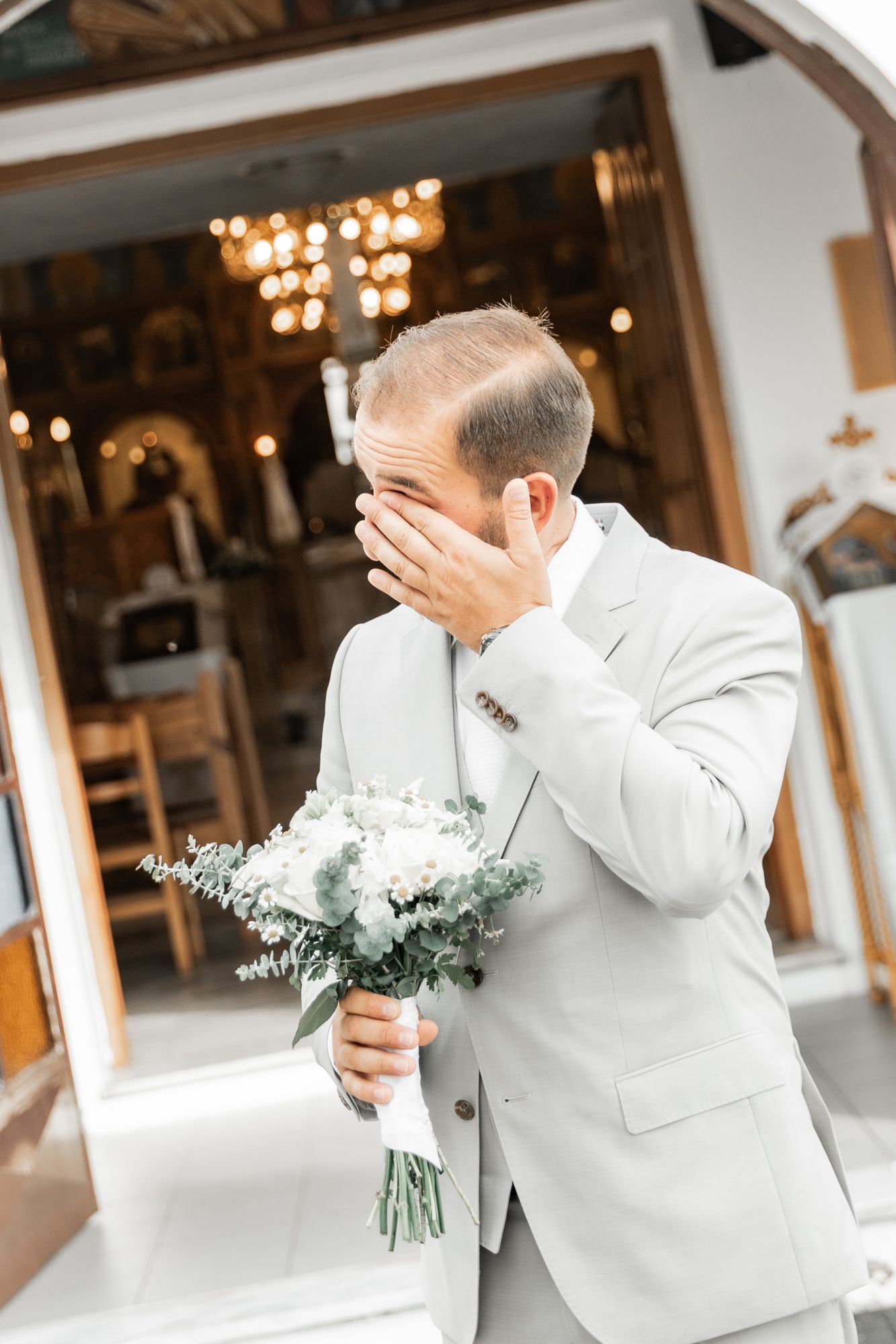 Emotional reactions captured during a first look moment at an indoor wedding venue.