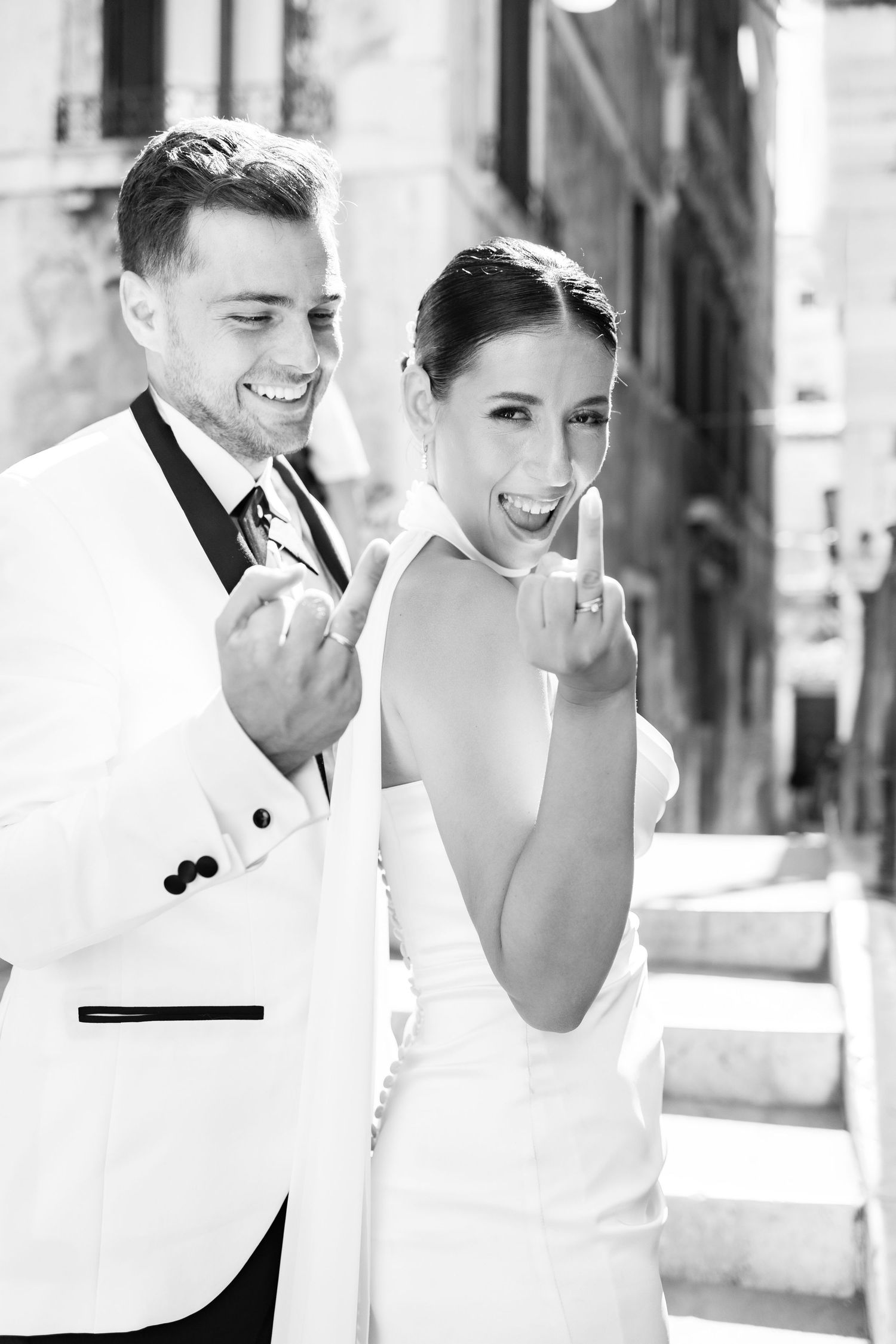 Candid moments of laughter and joy captured in a wedding photoshoot in Venice.