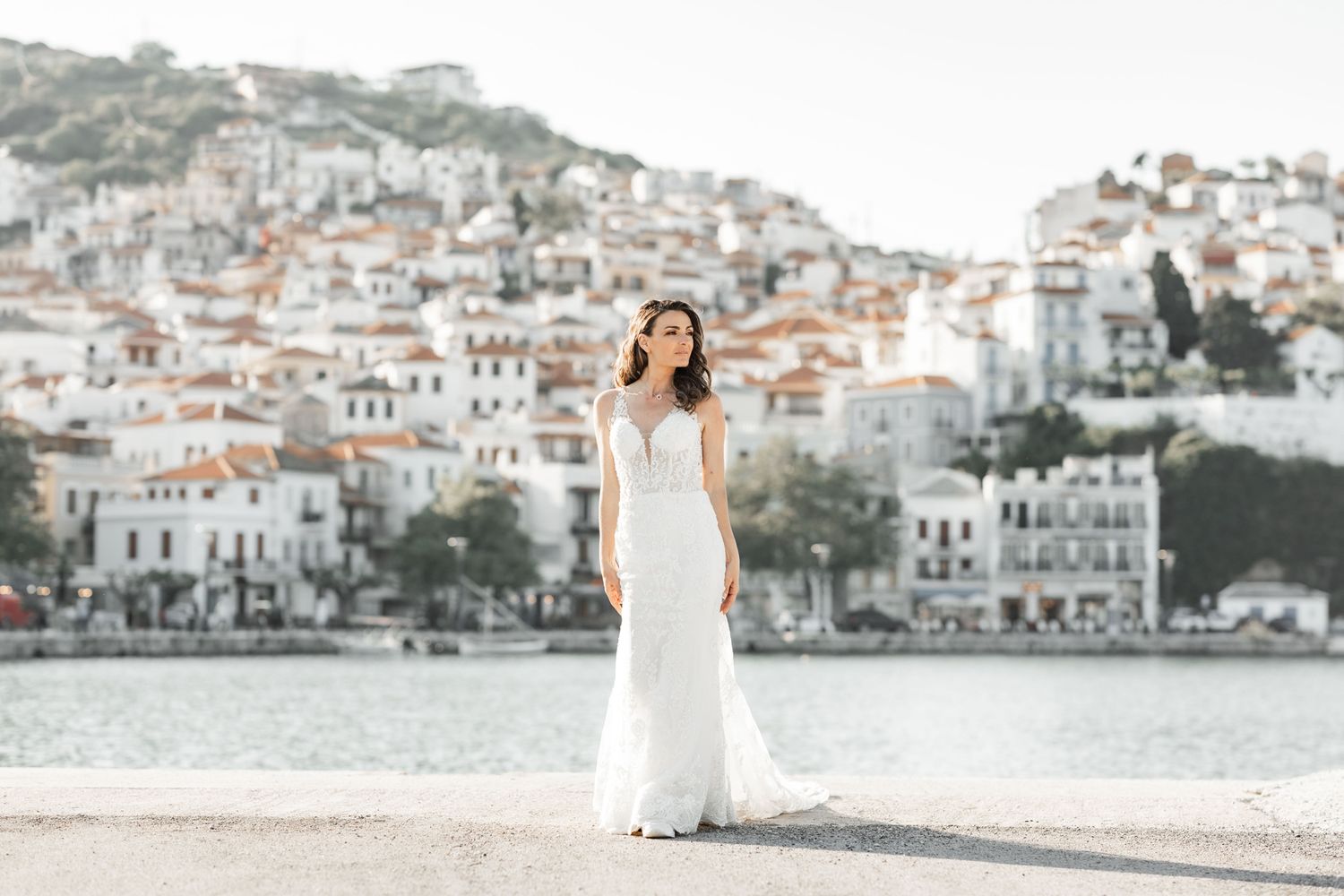 Panoramic view of coastal town with white buildings cascading down hillside.