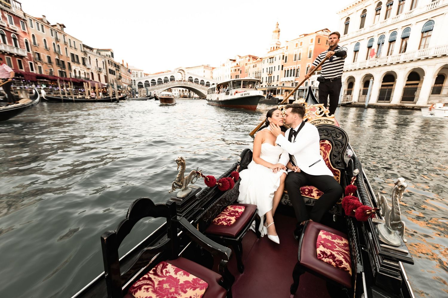 Romantic gondola ride through the scenic canals of Venice with historic buildings in the background.