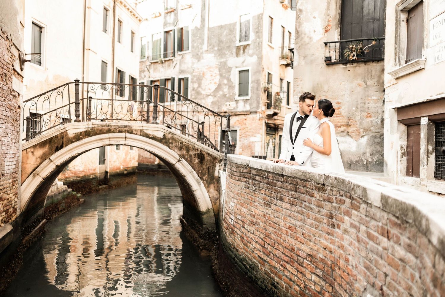 Elegant photoshoot along Venice's narrow canals with classic Italian architecture.
