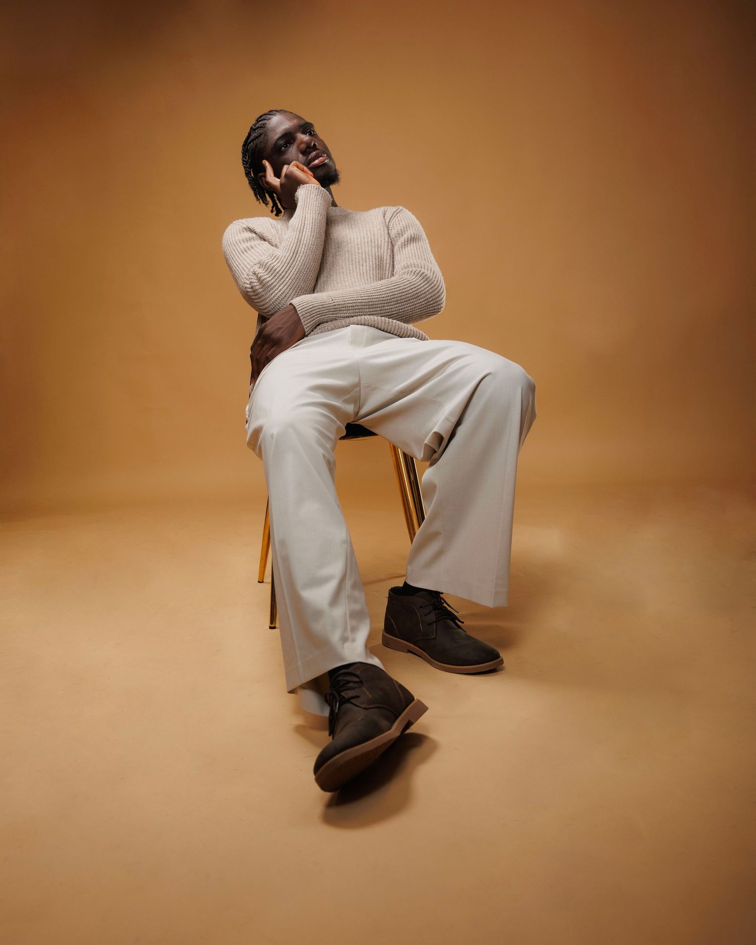 Person in white outfit sitting on chair in various poses against brown background showing different seated positions.