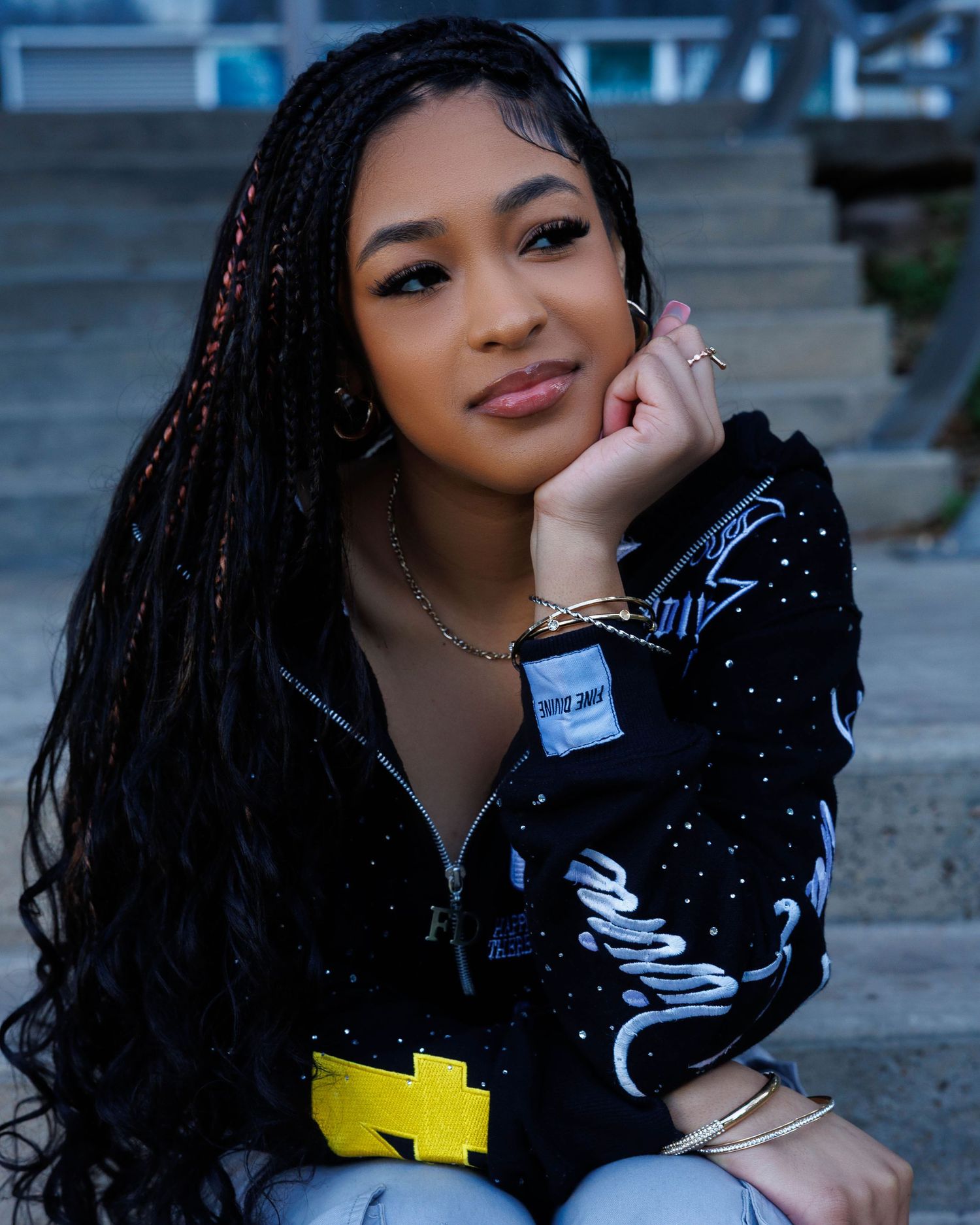 Fashion portrait on concrete steps with sparkly black outfit.