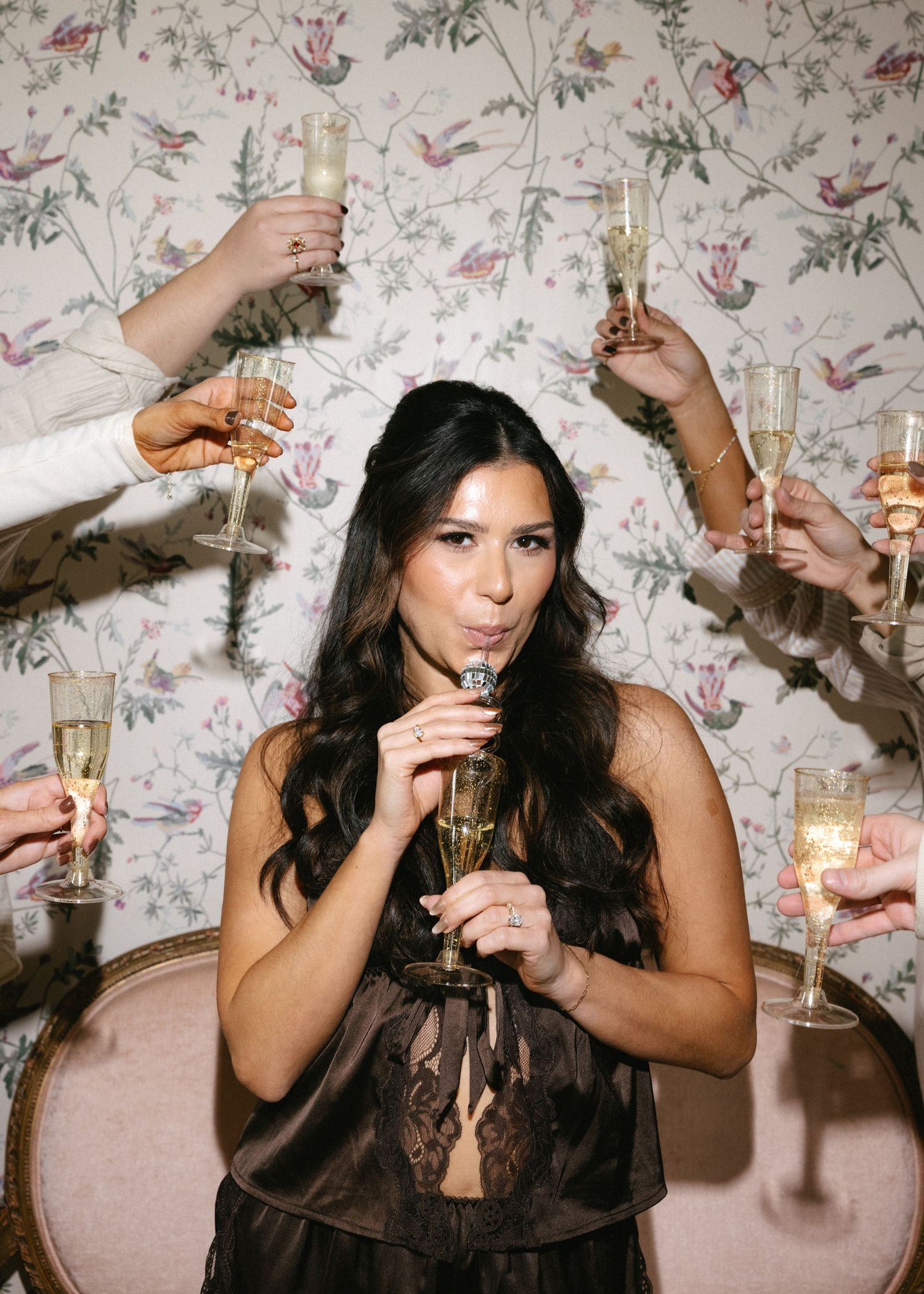 Series of celebratory champagne toasting photos against floral wallpaper background.