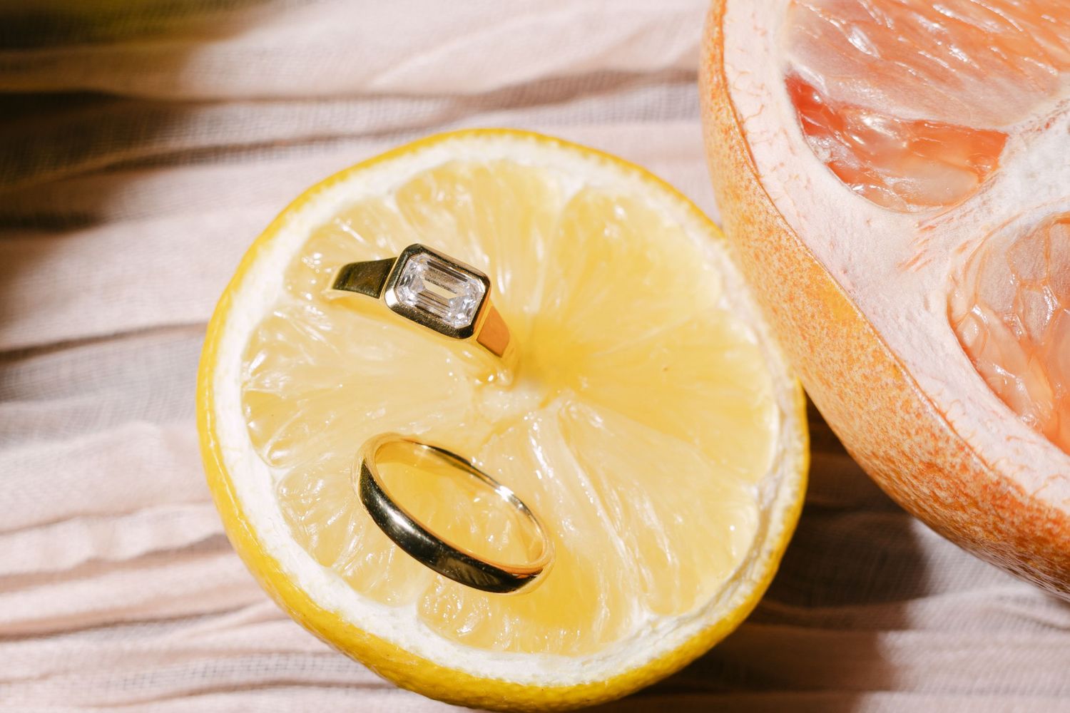 Fresh citrus slices of lemon and grapefruit arranged on a wooden surface.