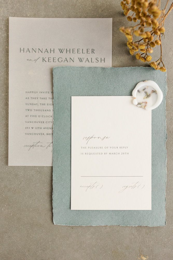 Elegant wedding invitation suite with sage green backing and dried floral accents.