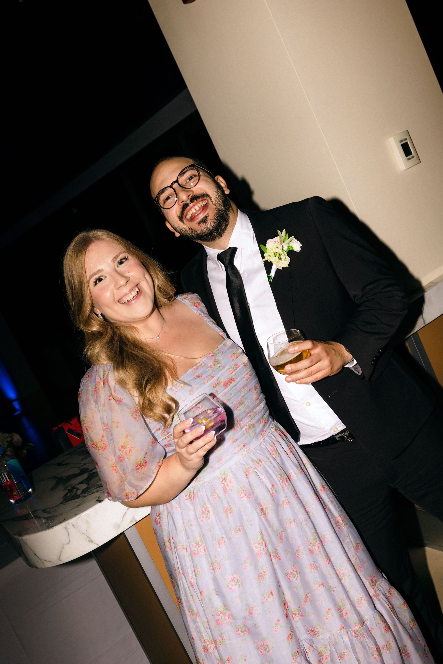 Wedding guests share joyful moments at an evening reception celebration.