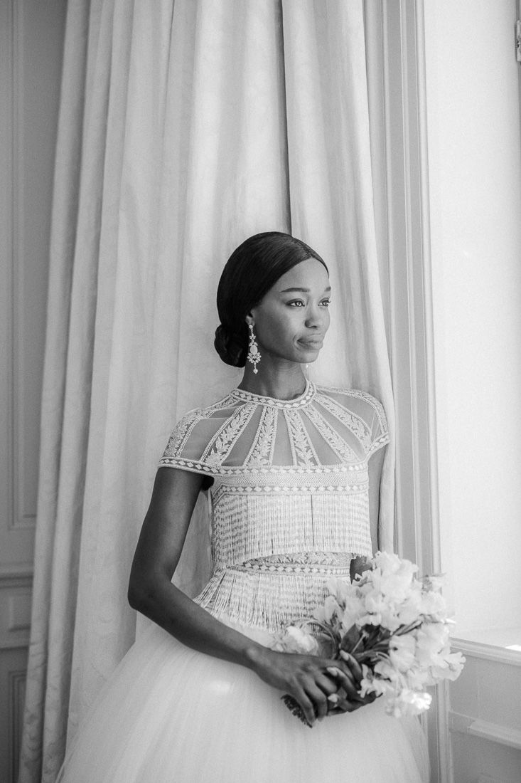 Black and white bridal portrait showcasing a vintage-inspired tea-length dress with beaded details.