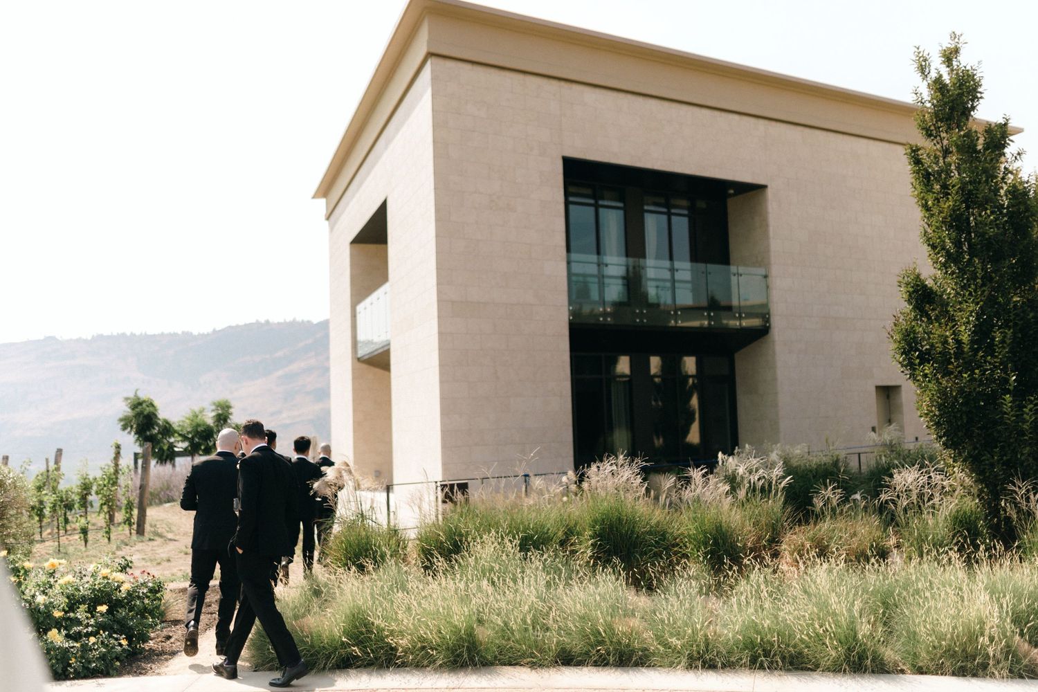 Modern architectural venue with desert mountains in the background.