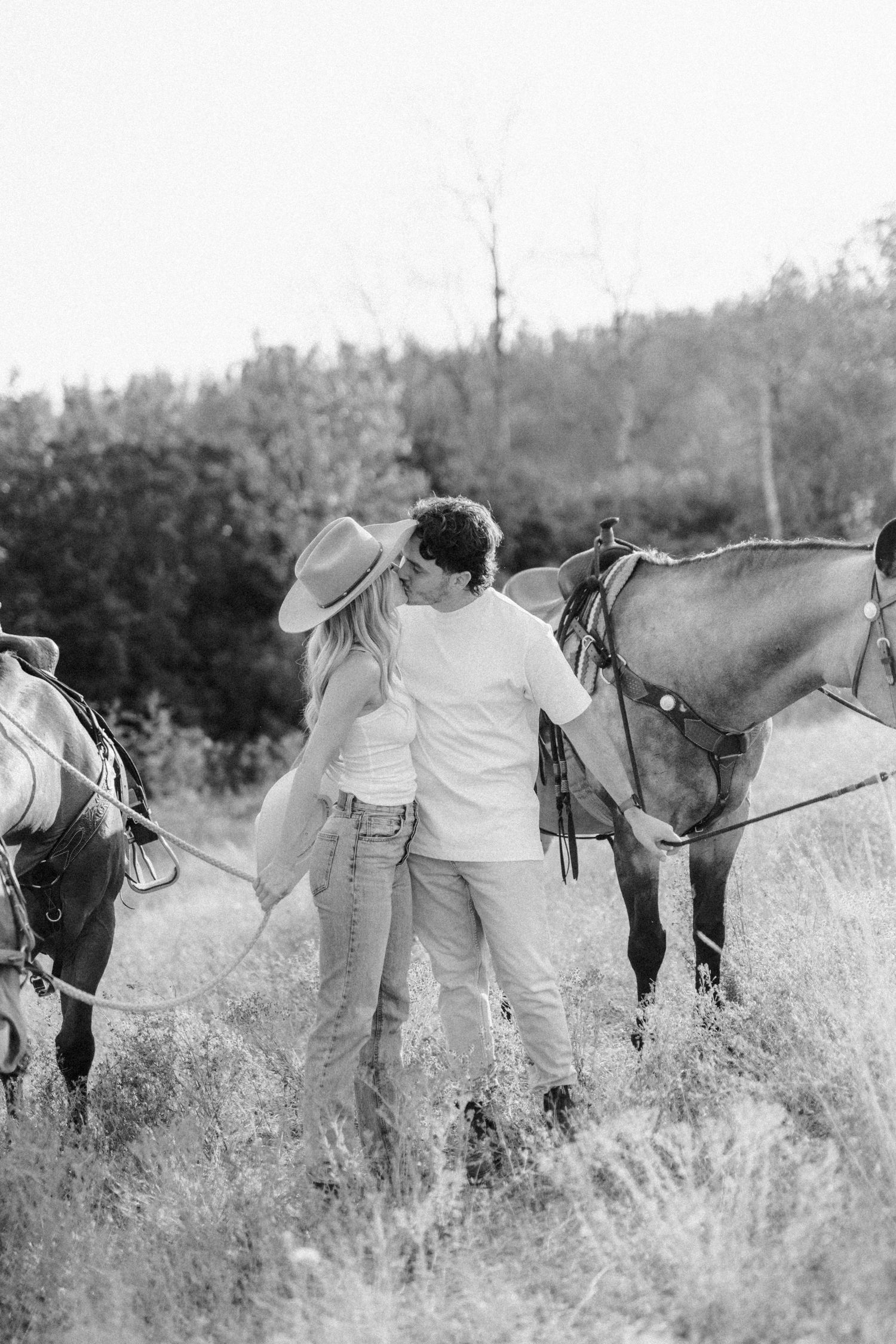 Series of black and white images showing people with horses in a rustic field setting.