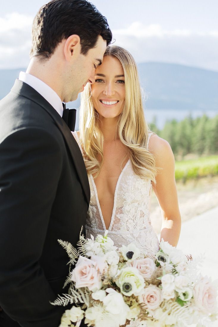 Intimate wedding portrait with mountain backdrop and soft natural lighting.