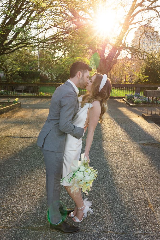 Romantic couple shares a tender moment in a park during golden hour.