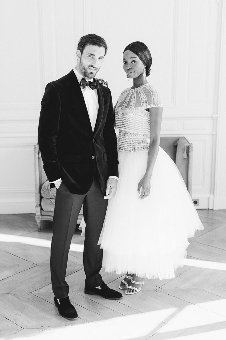 Black and white portrait of a wedding couple in classic formal attire.