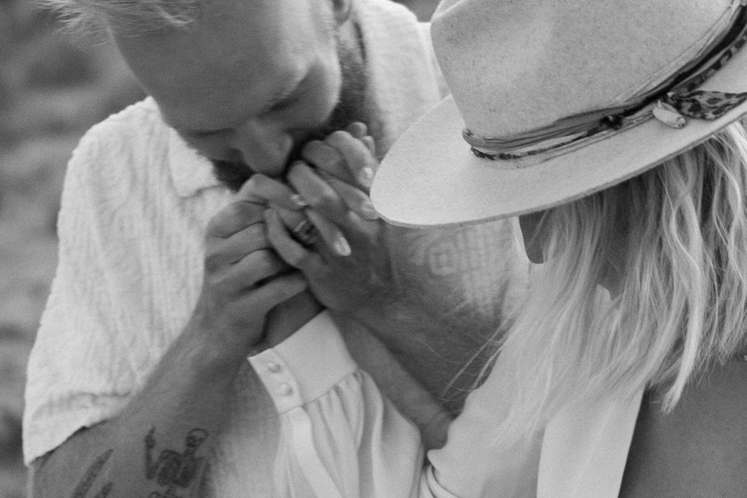 An emotional black and white close-up moment in the desert.