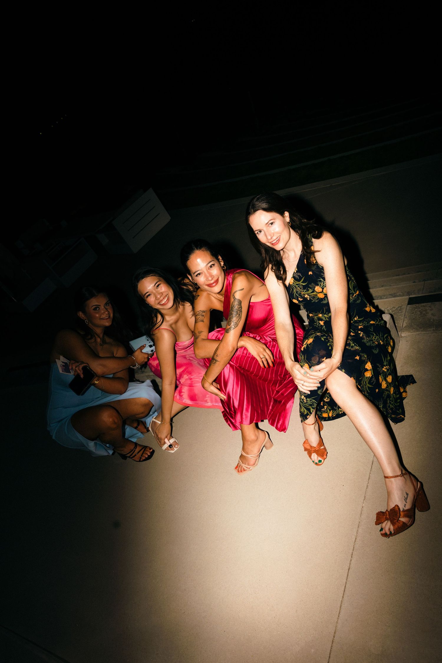 Creative low-angle shot of wedding guests sitting in a row during reception festivities.