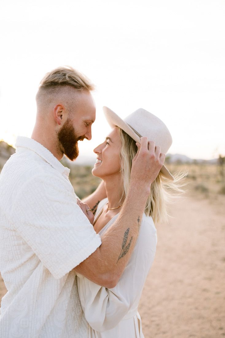 Romantic desert photoshoot with couple in matching white attire.