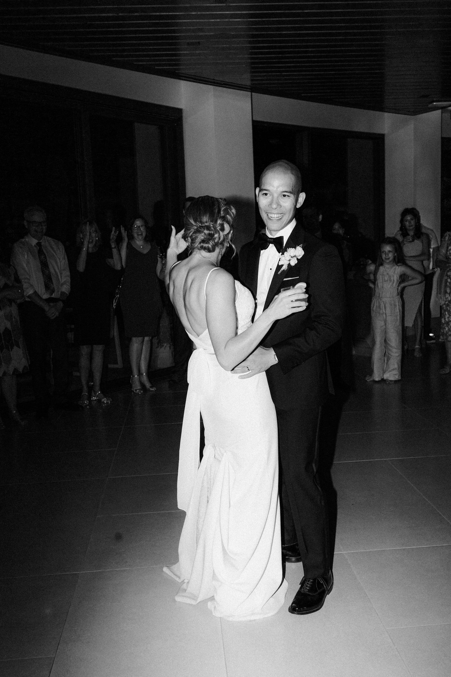 Black and white photo of a couple's first dance at their wedding reception.