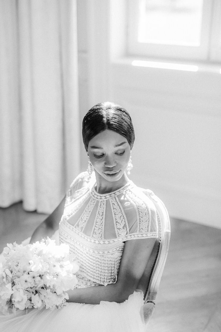 Black and white bridal portrait showing intricate lace details of wedding gown.