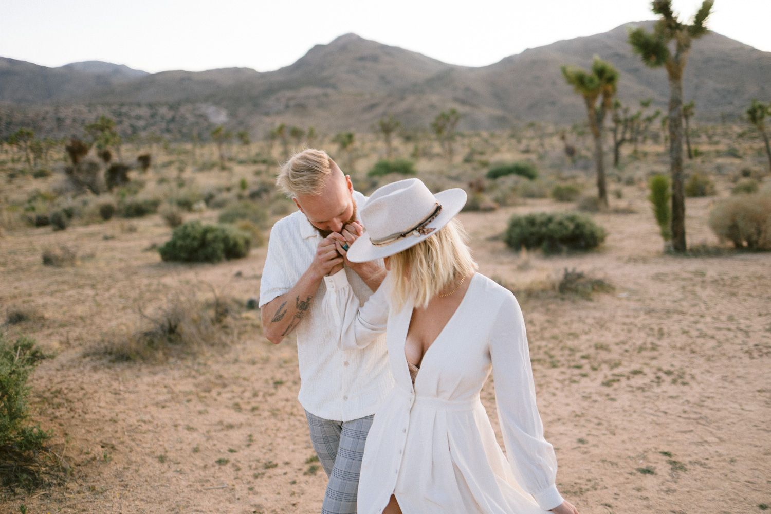 A joyful desert photography session with mountains and Joshua trees.