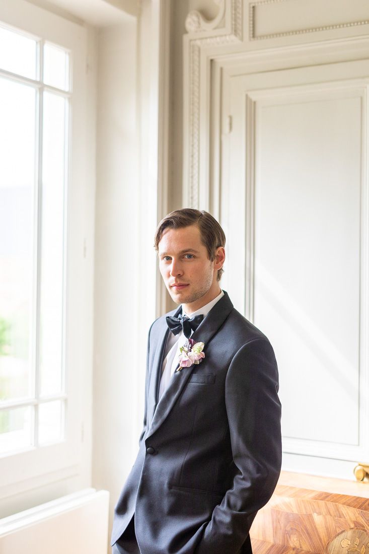 Formal portrait in classic interior with white moldings and natural window light.