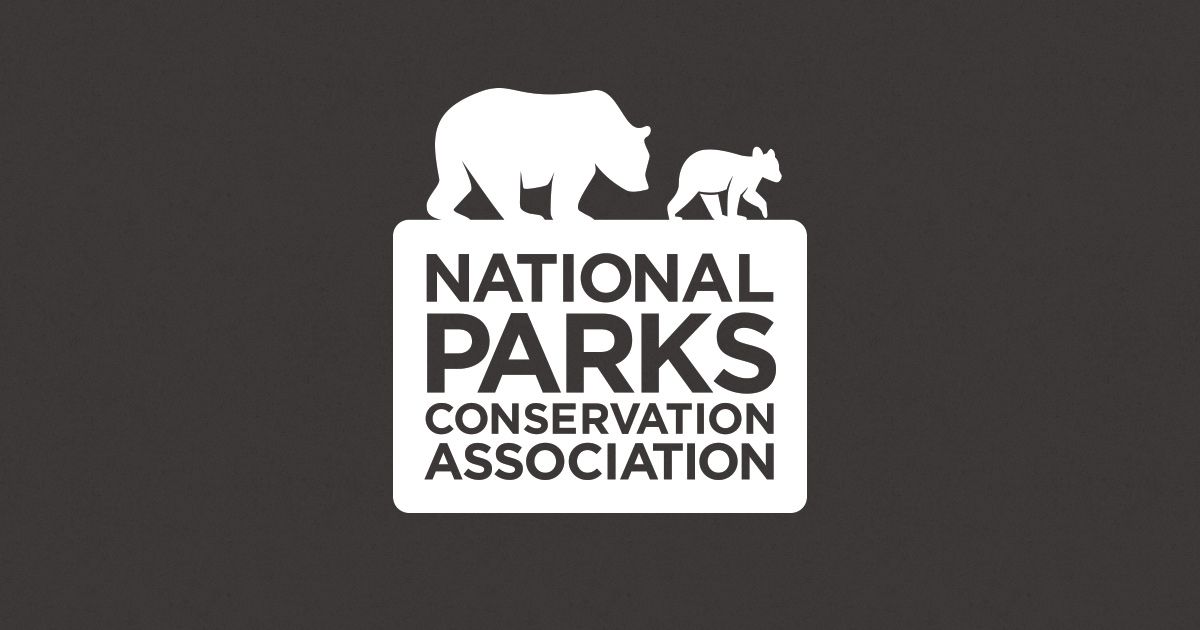 National Parks Conservation Association logo with white bear silhouettes on dark background.