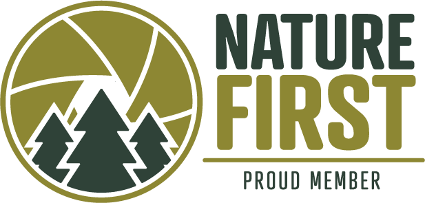 Nature First logo featuring mountain silhouettes and pine trees in olive green and dark green colors.