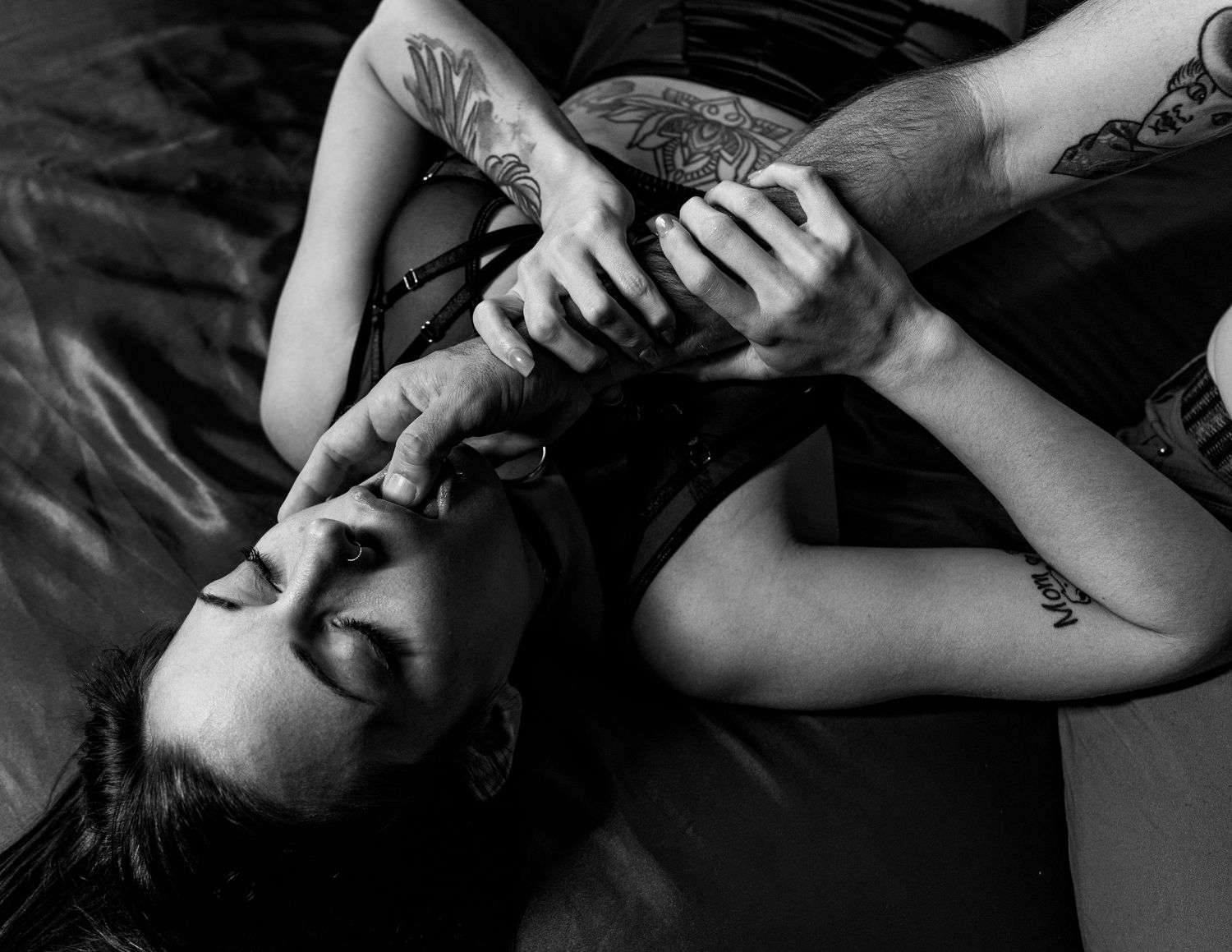 Intimate black and white portrait showing emotional connection and gentle touch.