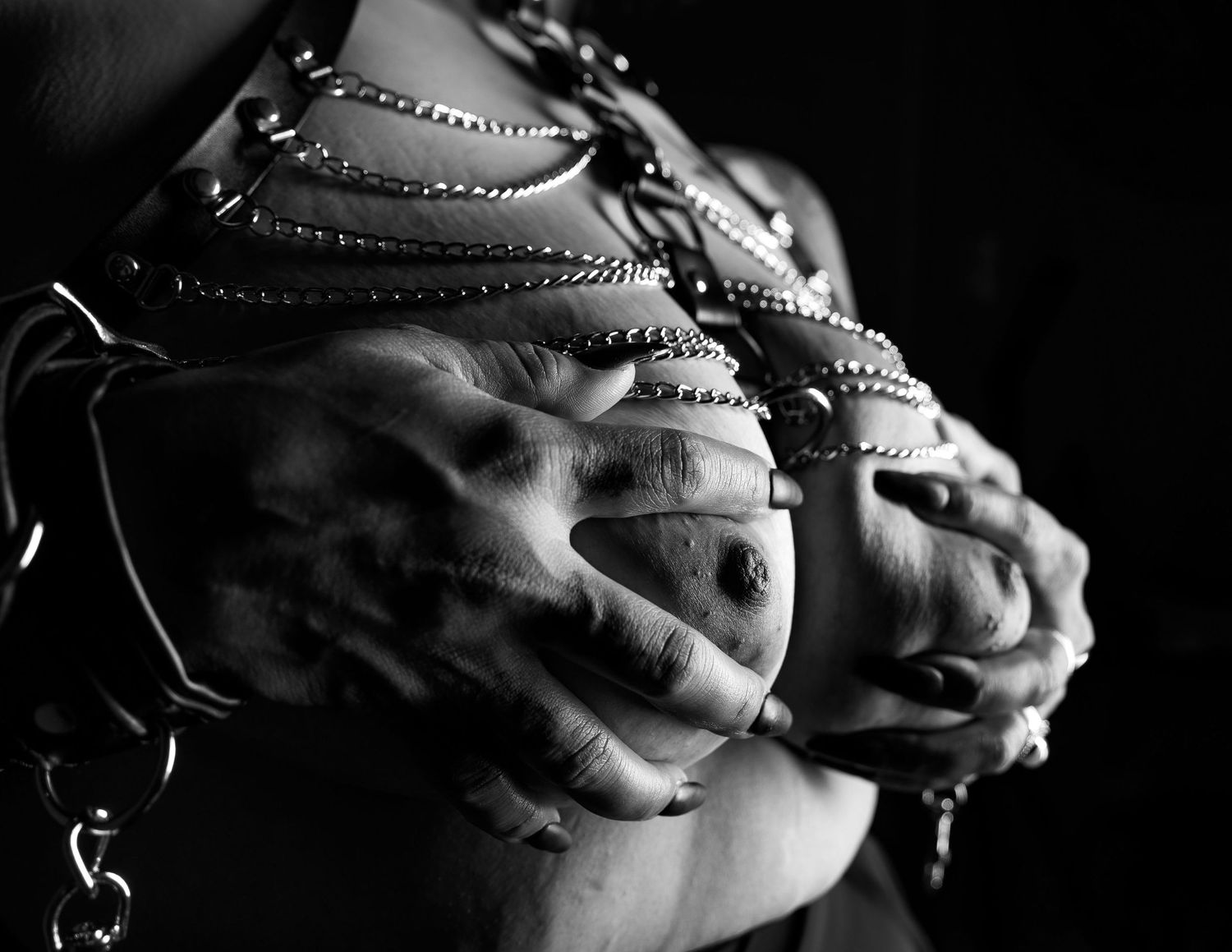 Black and white photograph of baseball shoes with dirt and grass stains showing wear from gameplay action on the field.