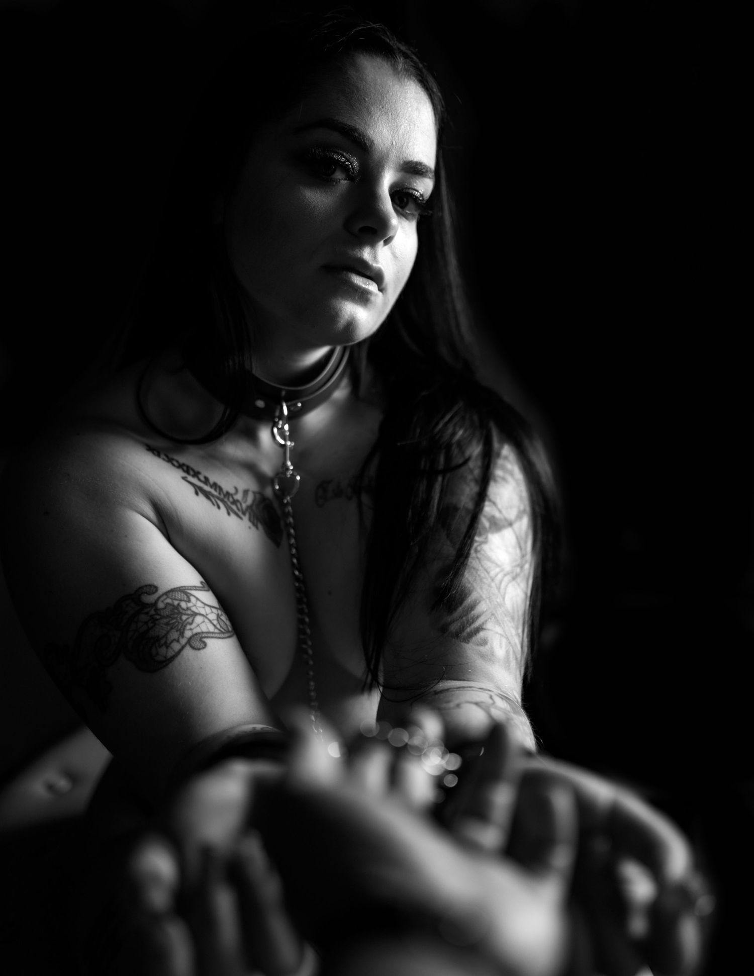 A dramatic black and white boudoir photo series showing artistic poses in moody lighting.