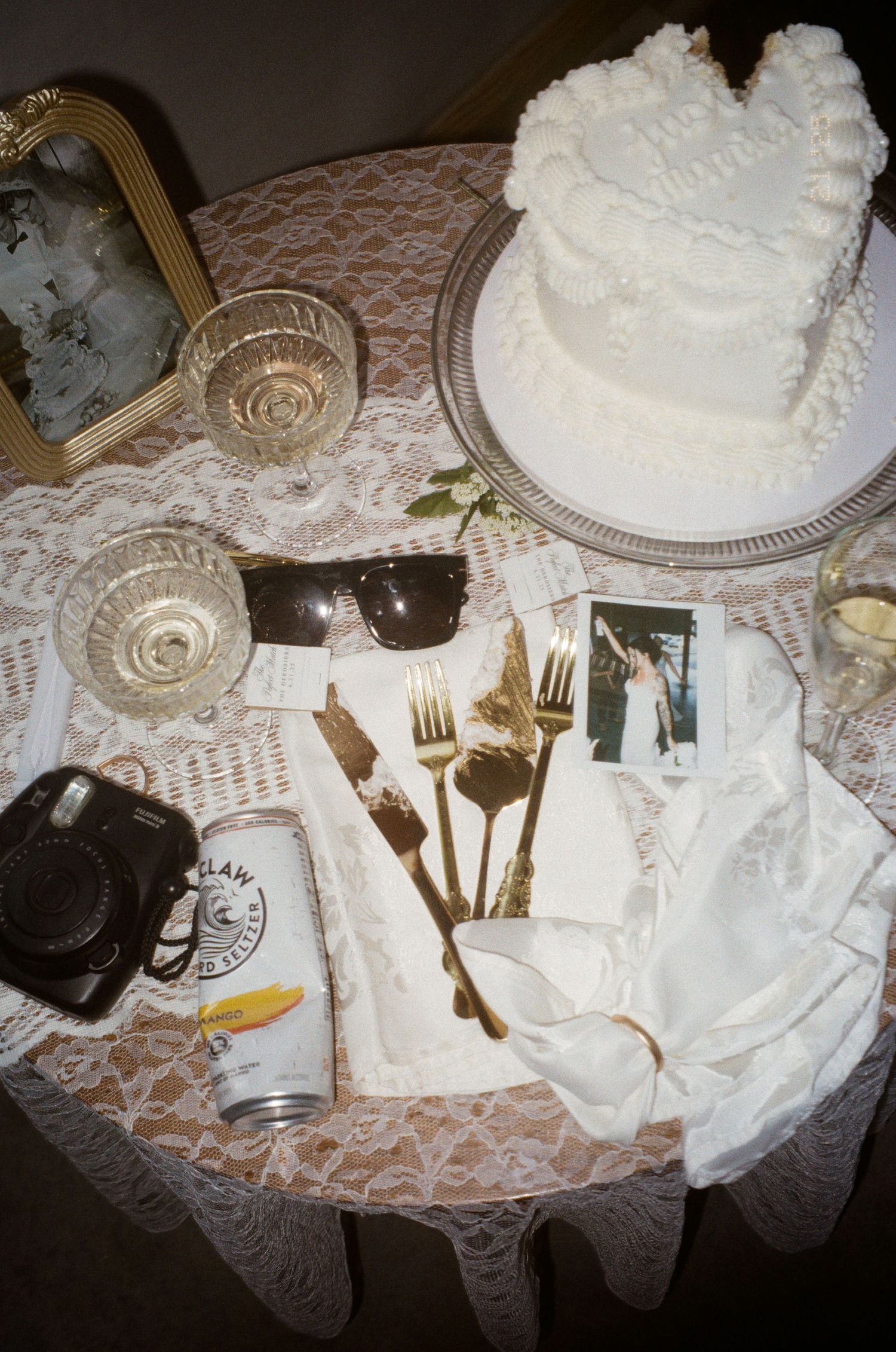 A white lace tablecloth with place settings, silverware, and elegant table decor for a formal dining occasion.