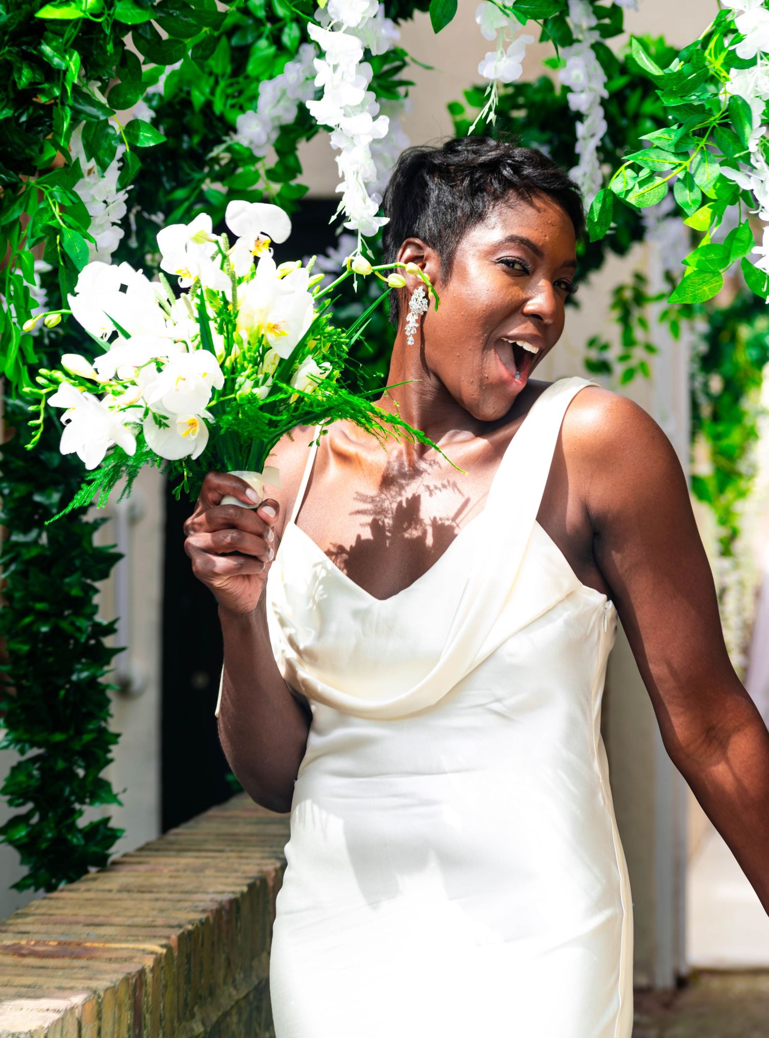 A bride being playful with her flowers after her civil wedding