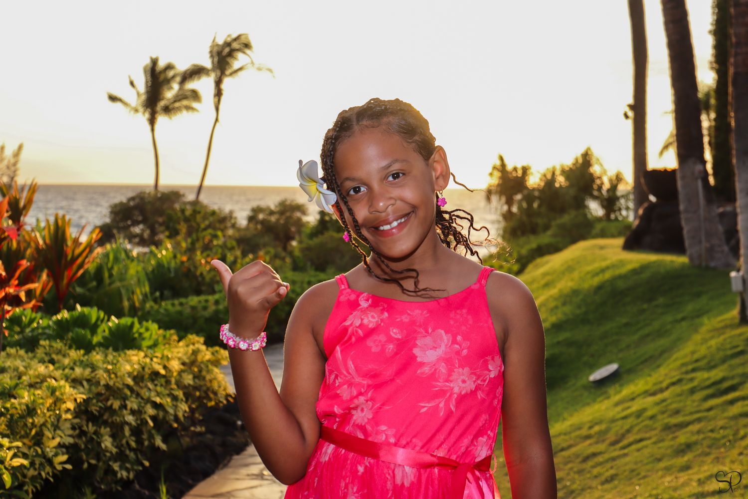 A photo taken by Sara Pang of an African-American girl doing a shakka at Hilton Waikoloa on Kona, Hawai'i.