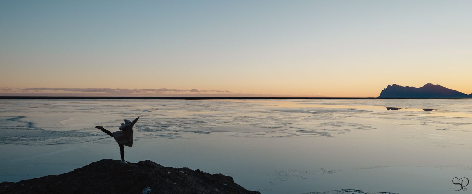 Sara Pang, a dancer, is doing an arabesuque off the sunset in iceland.