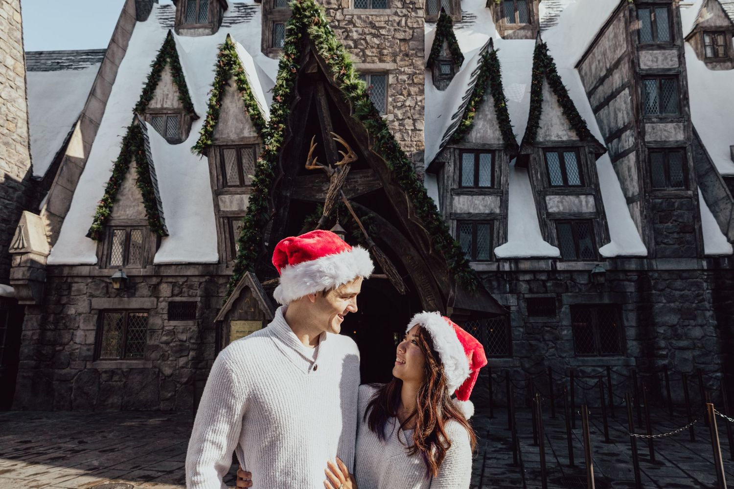 A picture by Sara Pang (MSK Productions) of a couple looking at each other at Wizarding World Universal Studios in Los Angeles, CA.
