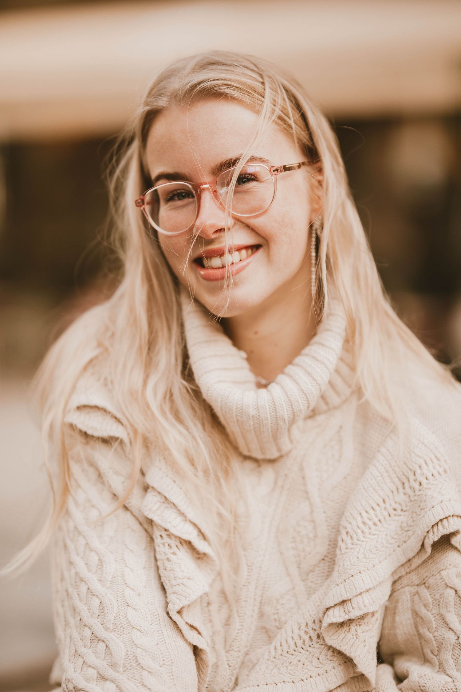 A series of photos showing someone in a cozy cream-colored knit sweater smiling warmly against a soft blurred background.