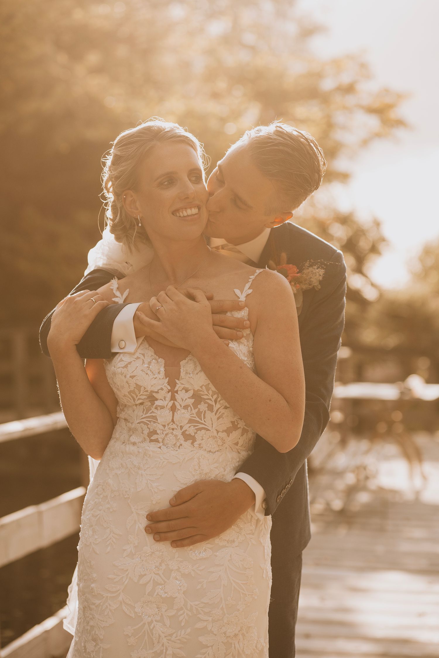 A tender moment between newlyweds captured in golden sunset light.