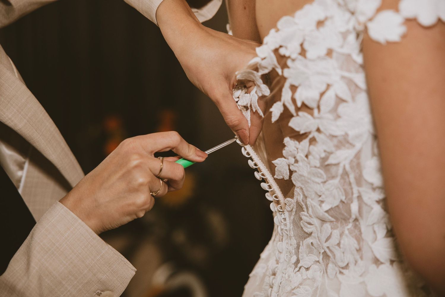 Close-up of delicate floral lace pattern on wedding gown.