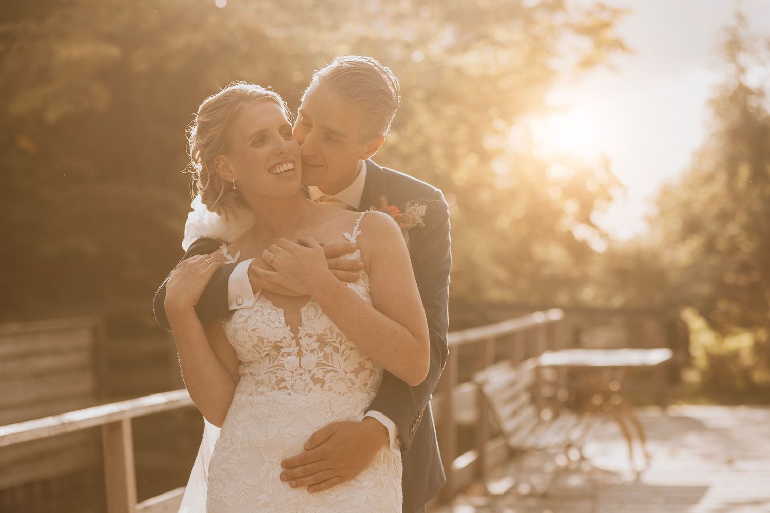 A couple shares an intimate moment during their outdoor wedding photoshoot at golden hour.