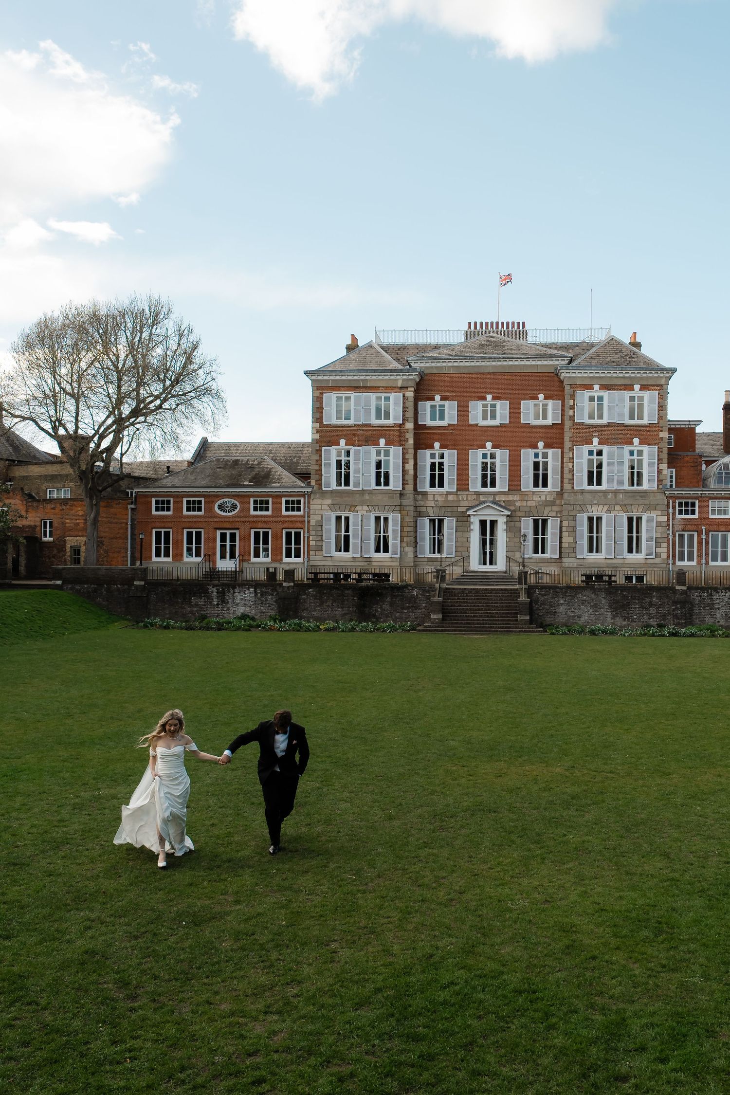 Bride and groom walking through York House gardens in spring